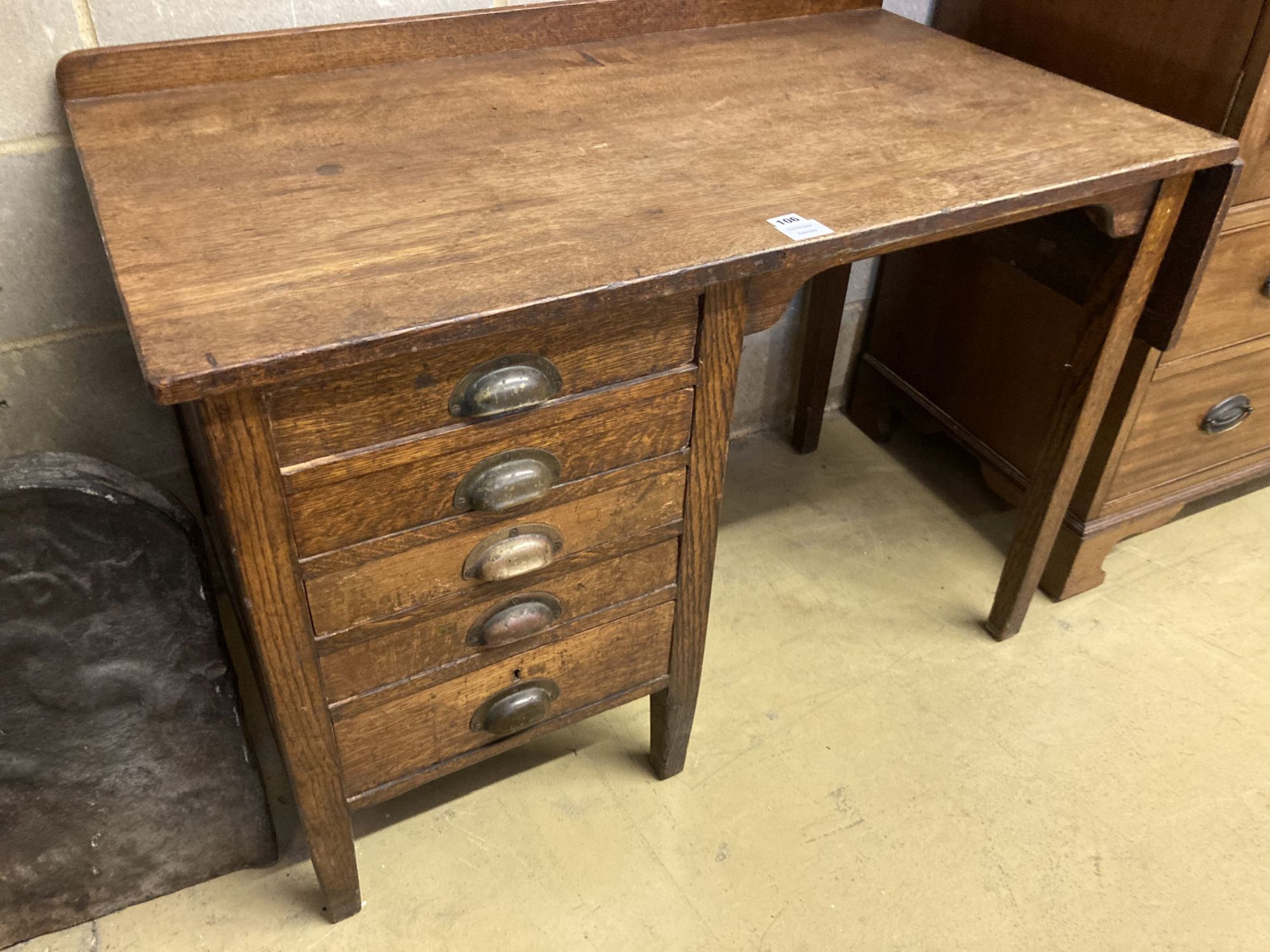 An early 20th century oak five drawer drop flap kneehole desk, width 108cm, depth 60cm, height 78cm